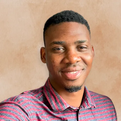 Close crop of Maxwell Cofie smiling against a warm beige background, in a circle